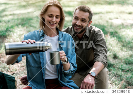 Joyful loving couple is ready to drink hot Joyful loving couple is ready to drink hot 34839948