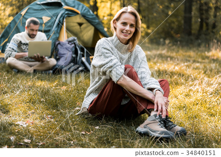 Cheerful married couple relaxing in forest Cheerful married couple relaxing in forest 34840151
