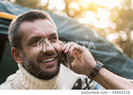 Carefree young man talking on mobile phone in Carefree young man talking on mobile phone in 34840159