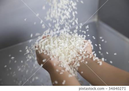 Children touching freshly milled rice Children touching freshly milled rice 34840271