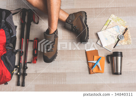 Man sitting near trip luggage 34840311
