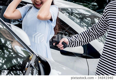 Thief is trying to steal the car at the public parking 34841940