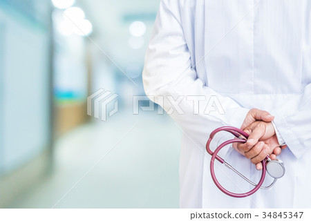 Doctor with stethoscope in his hand at hospital 34845347