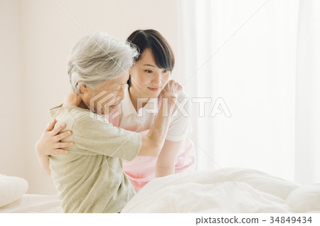 Care worker and senior visiting nursing home care 34849434