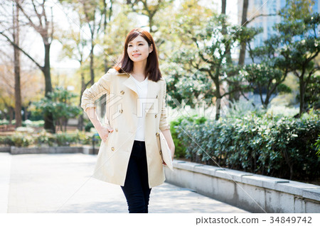 A woman in a trench coat 34849742