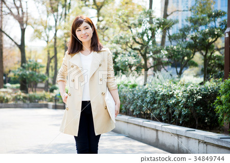 A woman in a trench coat 34849744
