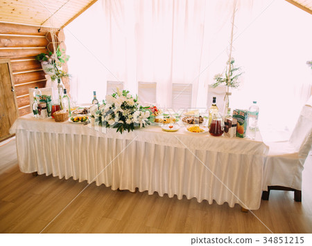 The wedding table set full of dishes and decorated 34851215