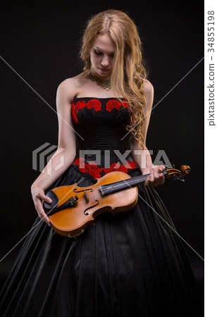 Blond young girl in concert dress with the violin 34855198
