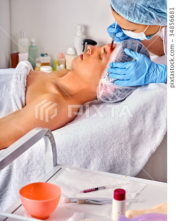 Dermal fillers of man in spa salon with beautician 34856681