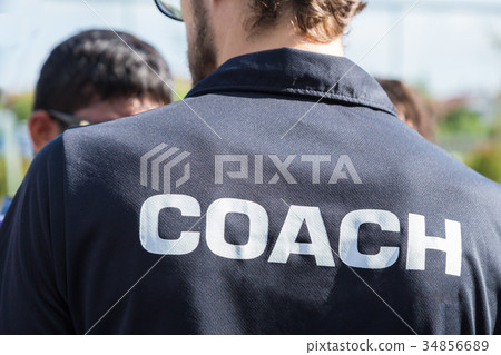 back of a sport coach's black shirt, Coach word 34856689