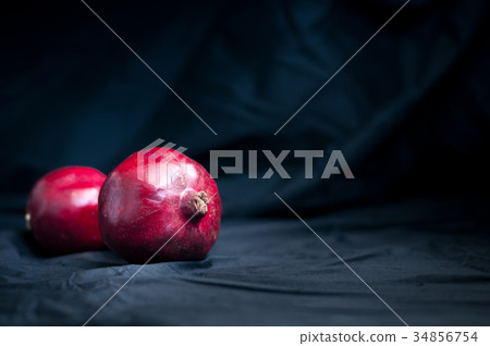 fresh pomegranate on a black background 34856754