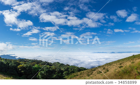 Mist over the mountains with blue sky background Mist over the mountains with blue sky background 34858899