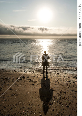 Girl standing in Sunrise famous Hopewell Rocks 34859019