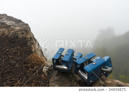 Rock climbing mount on a stone on a gray sky 34859875