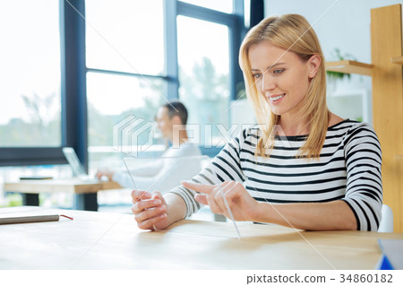 Beautiful blonde woman looking at the tablet Beautiful blonde woman looking at the tablet 34860182