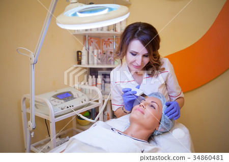 doctor cosmetologist makes the procedure a woman 34860481