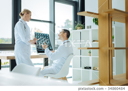 Joyful positive doctors talking to each other 34860484