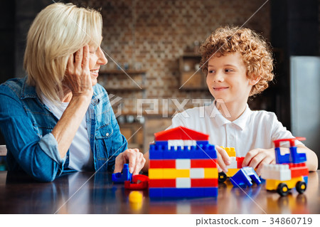 Smart curly haired kid spending time with Smart curly haired kid spending time with 34860719