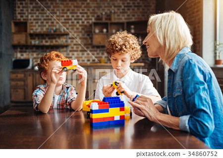 Redhead kid showing car toy to his grandma Redhead kid showing car toy to his grandma 34860752