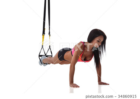 Woman exercising with suspension straps 34860915