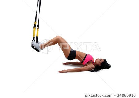 Woman exercising with suspension straps 34860916