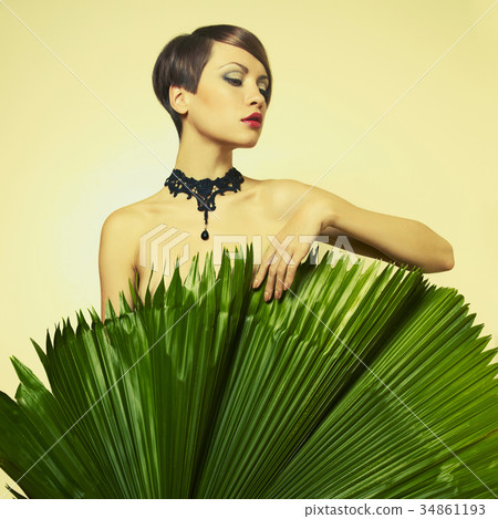 Beautiful lady with palm leaves Beautiful lady with palm leaves 34861193