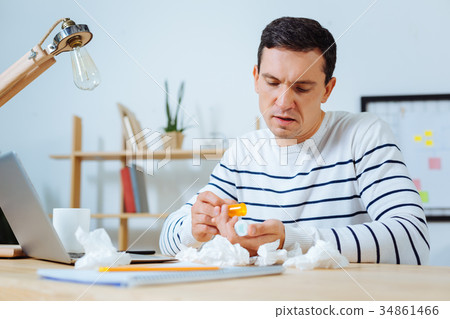 Attentive office worker pouring down pills Attentive office worker pouring down pills 34861466