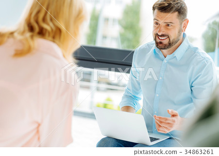 Handsome brunette talking to his partner Handsome brunette talking to his partner 34863261