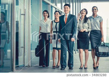 Asian business team of executives walking into Asian business team of executives walking into 34863280