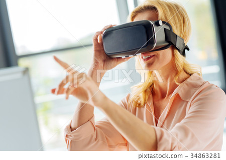 Positive delighted woman wearing special mask Positive delighted woman wearing special mask 34863281