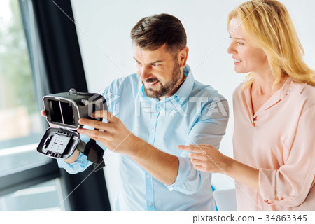 Happy brunette playing with new device Happy brunette playing with new device 34863345