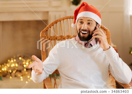 Lively man being surprised while talking on the Lively man being surprised while talking on the 34863403