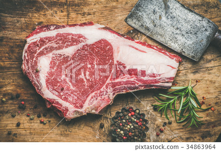 Raw beef steak rib-eye with seasoning and knife 34863964