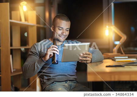 Relaxed male person drinking beer 34864334