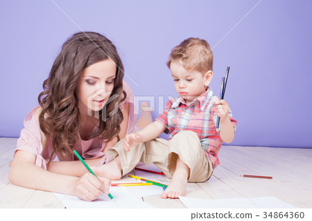 mother and young son play paint crayons mother and young son play paint crayons 34864360