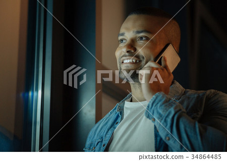 Positive delighted male while talking 34864485