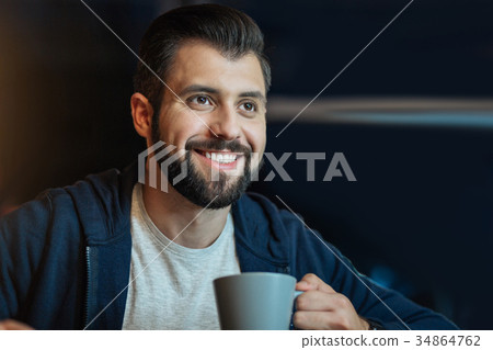 Handsome brunette keeping smile on his face Handsome brunette keeping smile on his face 34864762
