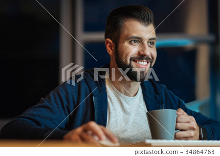 Smiling male person working at night Smiling male person working at night 34864763