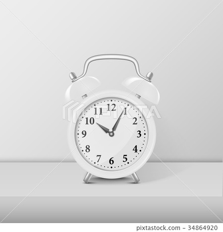 White alarm clock closeup standing on white table 34864920
