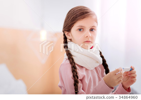 Cute girl with big grey eyes holding a thermometer 34864960