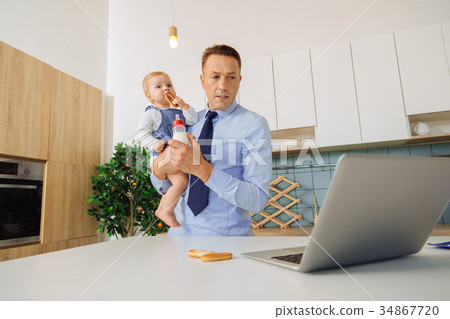 Smart handsome man looking at the laptop screen 34867720