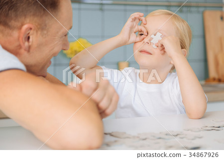 Cute nice girl playing with puzzle pieces 34867926