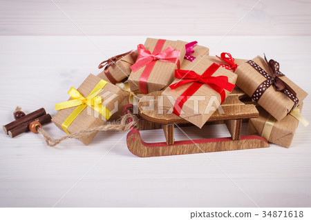Wooden sled and wrapped gifts for Christmas 34871618
