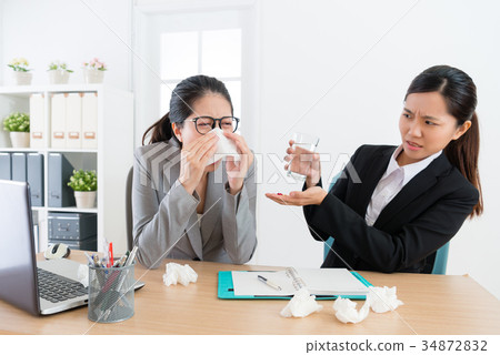 female business woman sneezing during conference 34872832
