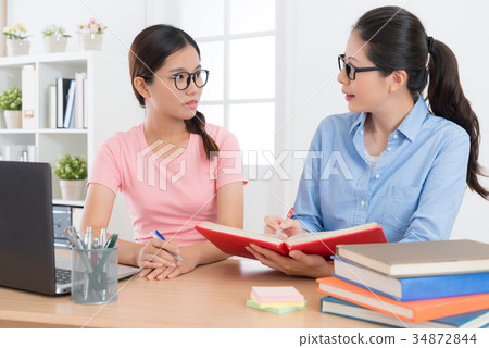 confident education tutor woman holding textbook confident education tutor woman holding textbook 34872844