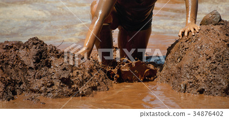 Mud race runners obstacle race runner in action Mud race runners obstacle race runner in action 34876402