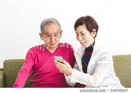 Senior couple smartphone Senior couple smartphone 34876947