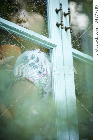 Rainy day woman spending at home 34877597