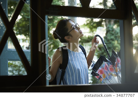 Woman going out on a rainy day 34877707