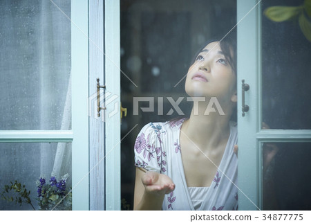 Rainy day woman spending at home 34877775